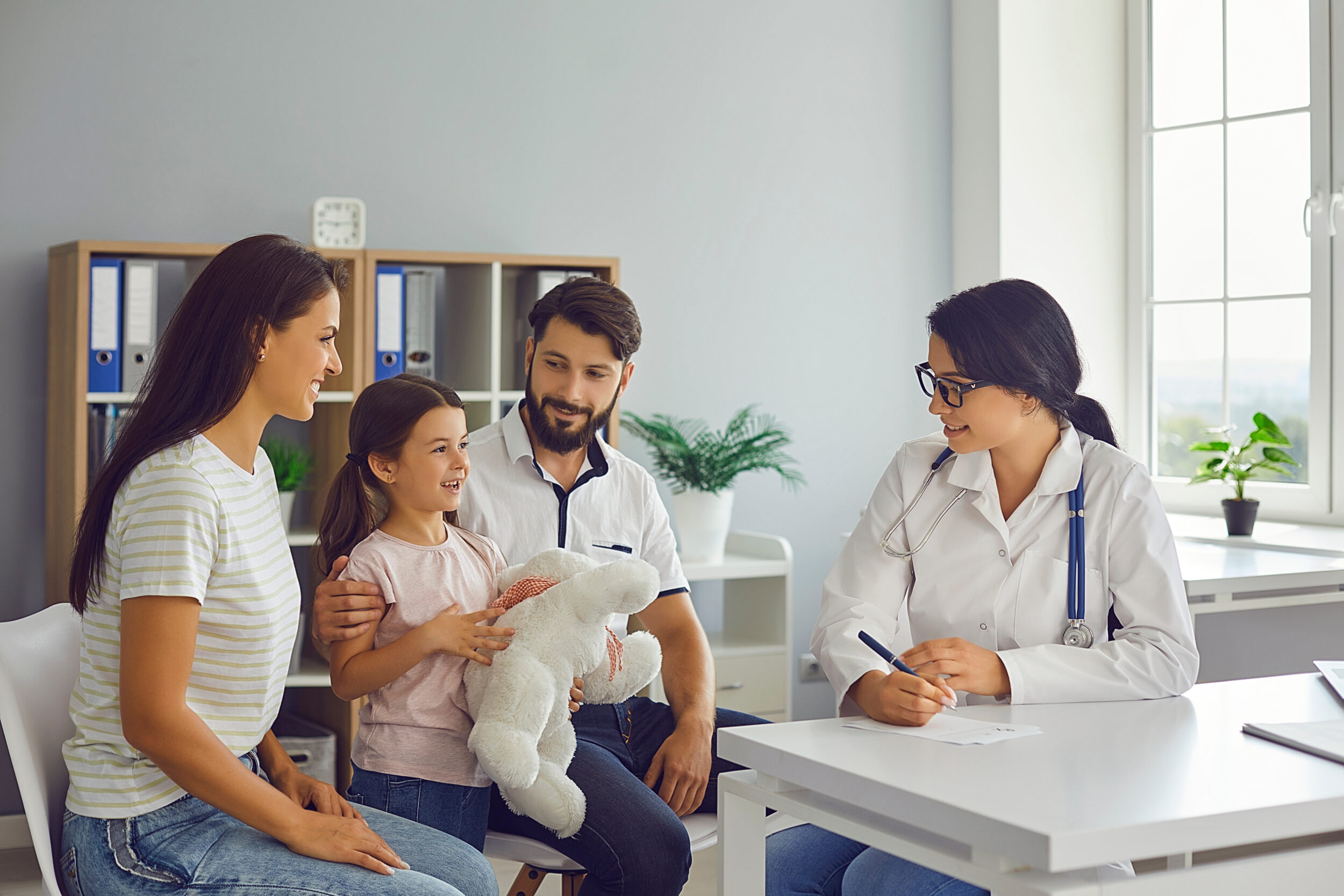 Mother, father, and daughter meeting with their family medicine physician for simplified care