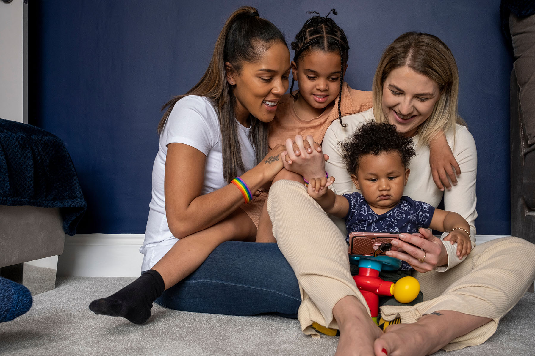 Mothers and sons looking at smart phone