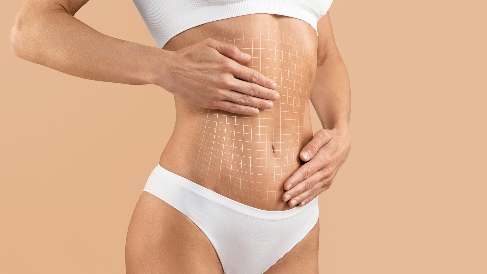 Bare abdomen with white grid lines and hands resting on the stomach
