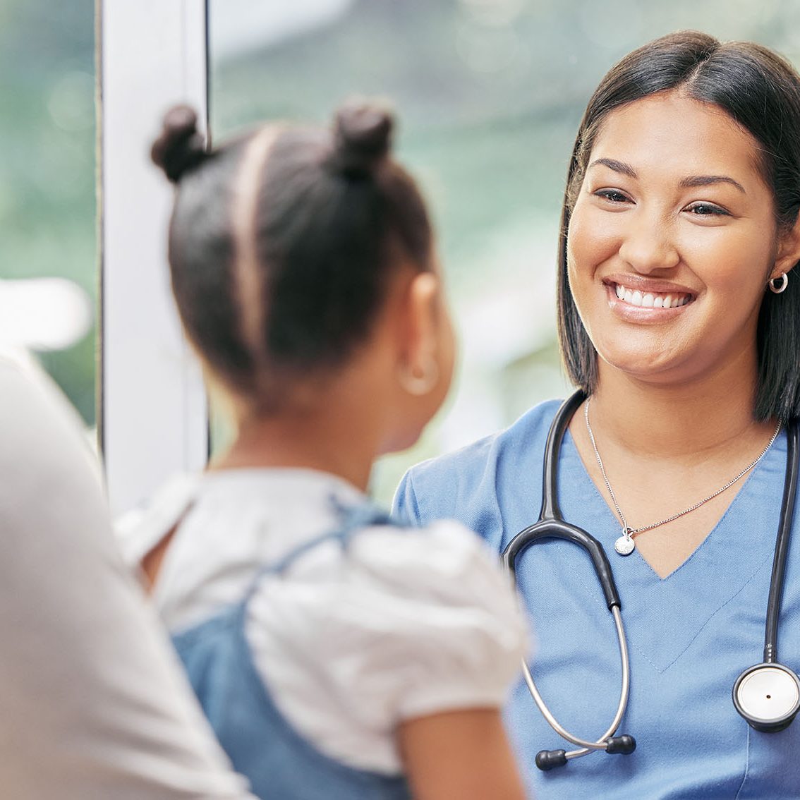 Father, child and nurse talking for health care in a hospital while happy at consultation. African woman pediatrician or doctor, man and kid patient for medical check, family insurance or development